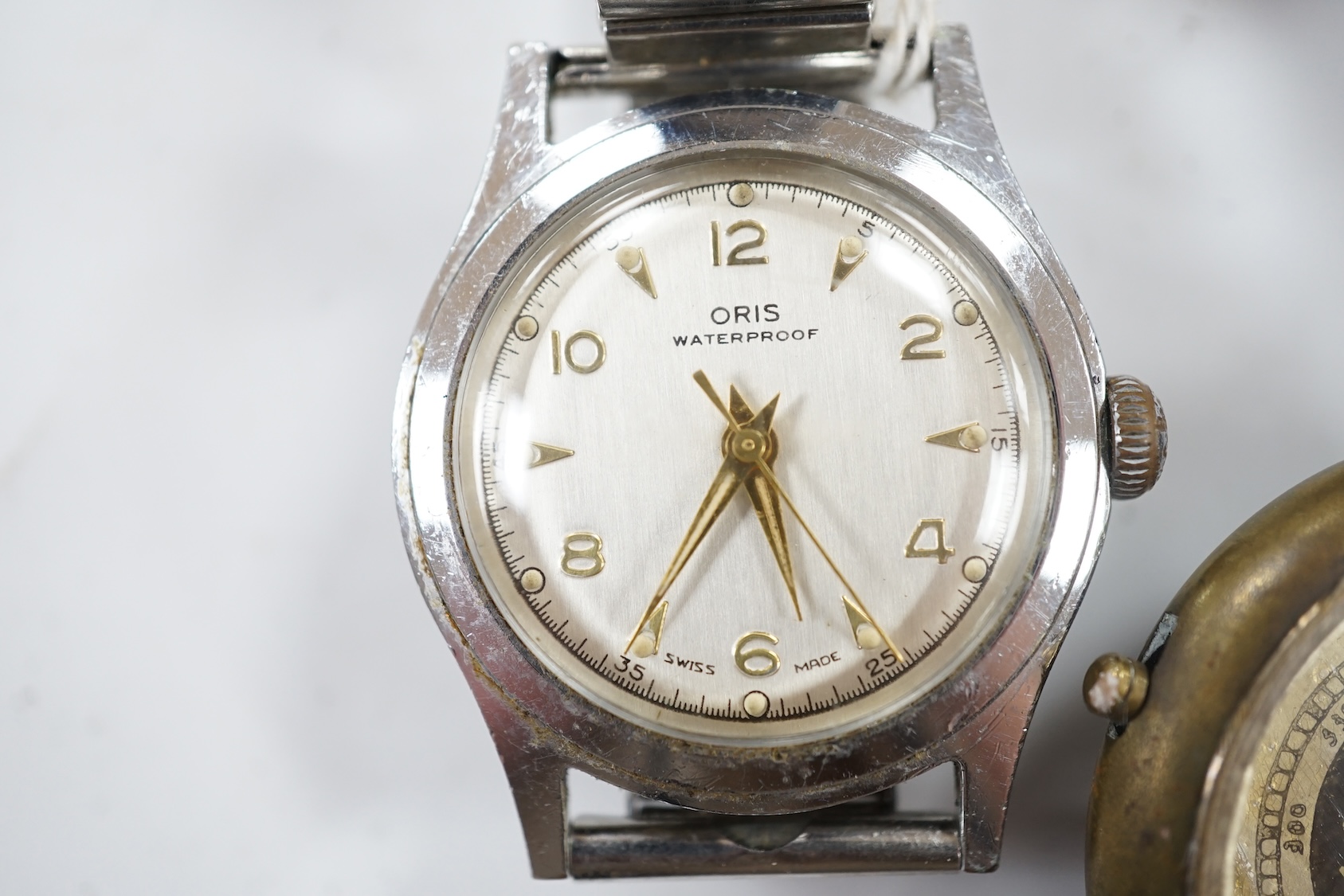 A gentleman's stainless steel Oris manual wind wrist watch and a base metal wrist compass. Condition - poor to fair